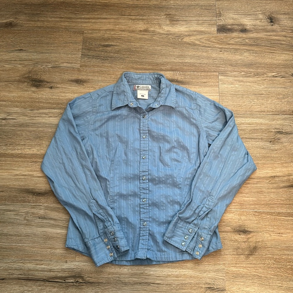 Columbia blue collared shirt with pearl snaps. Size small.